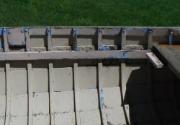 Roved above thwart riser, clenched below