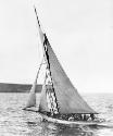AKARANA with its cruising sails set, crossing Sydney Heads, some time in the 1890s.