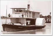 PS INDUSTRY around 1910 with a pile driving barge in tow.
